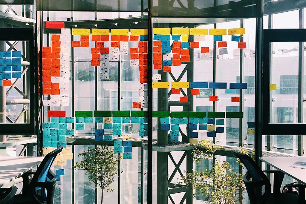 office with windows full of post its of a project