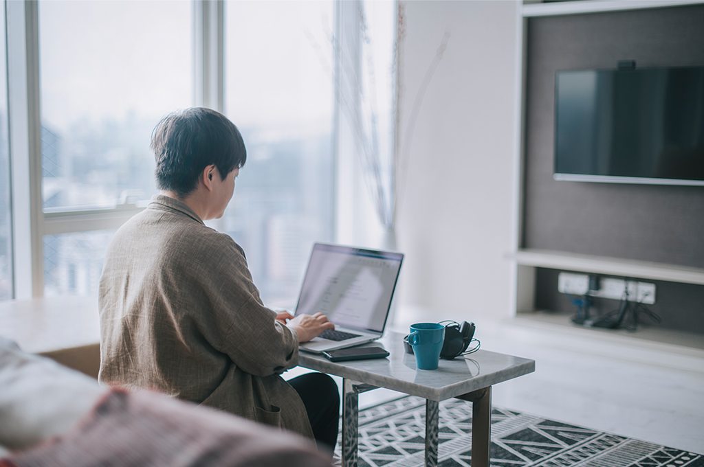 woman works on the computer from her living room