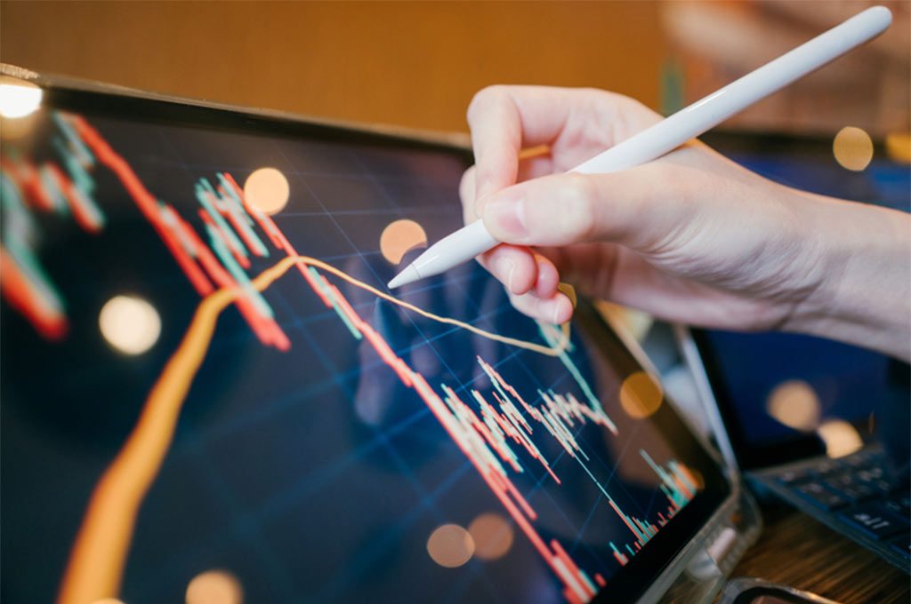 Investor reviews financial information on his tablet.