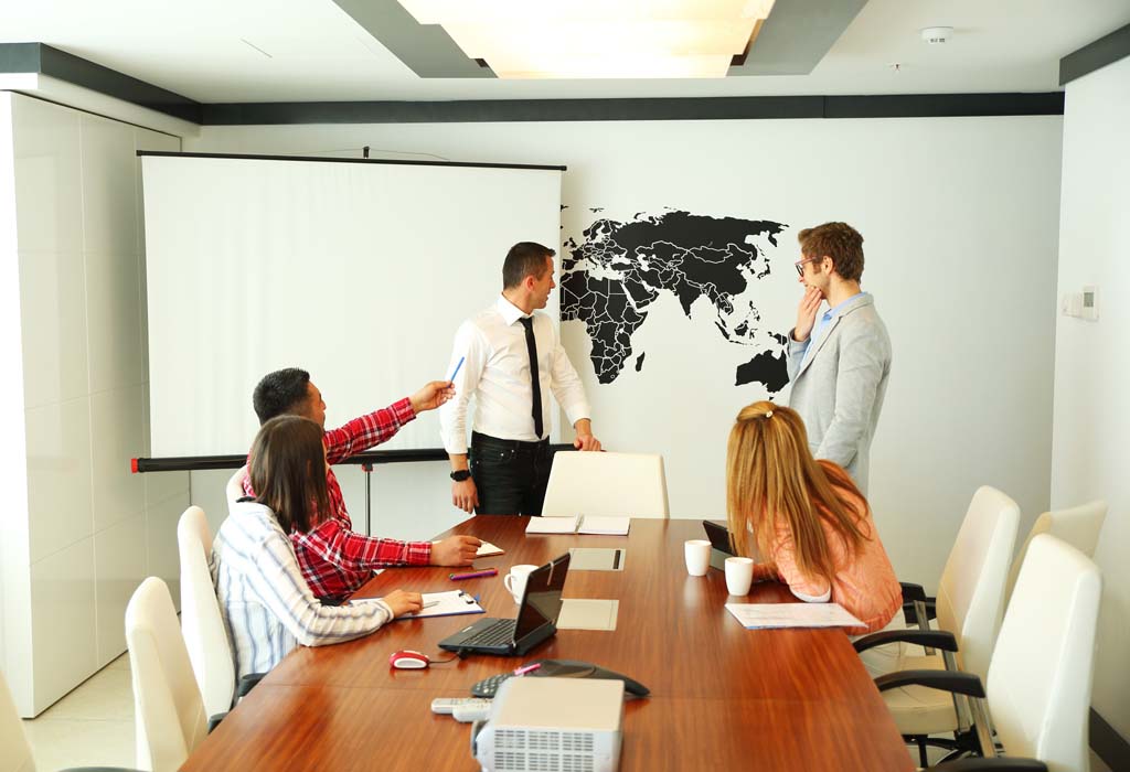 Meeting. A discussion taking place in front of a world map.