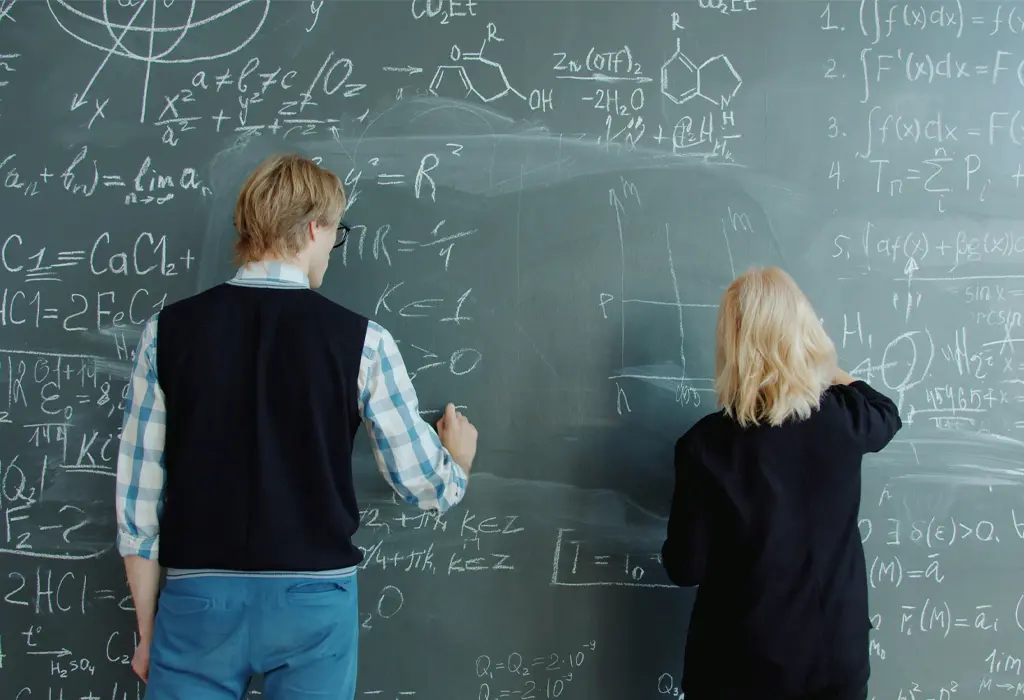Two scientists working out some calculations together.