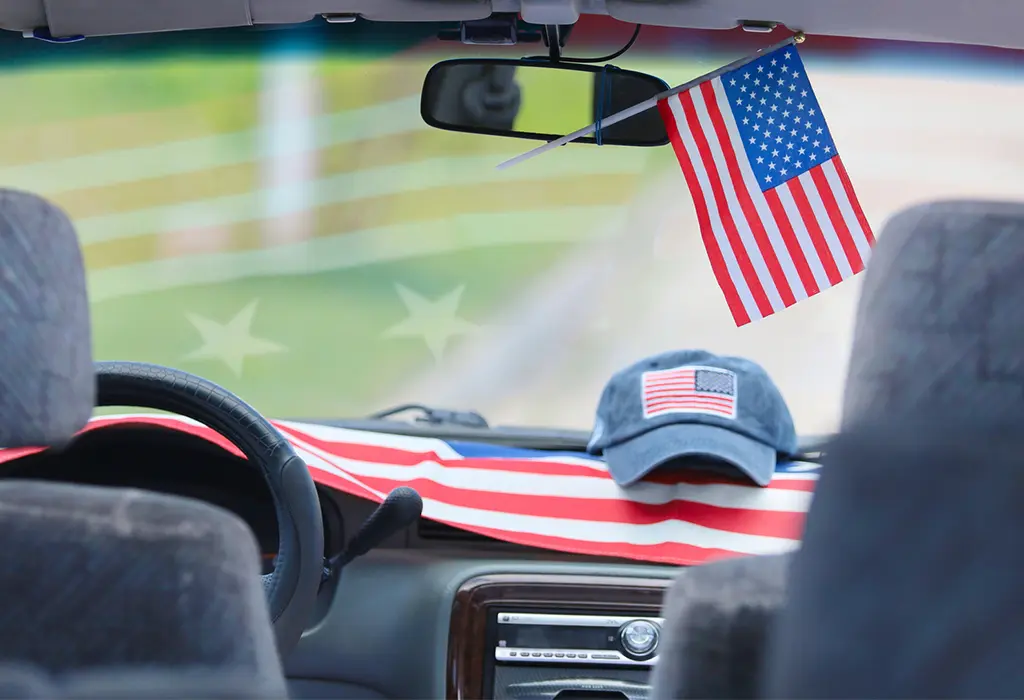Inside view of a car that is full of US flags