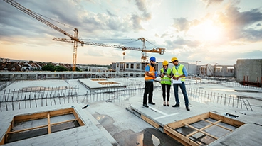 https://www.iese.edu/insight/wp-content/uploads/sites/3/2026/04/construction-site-crane.webp